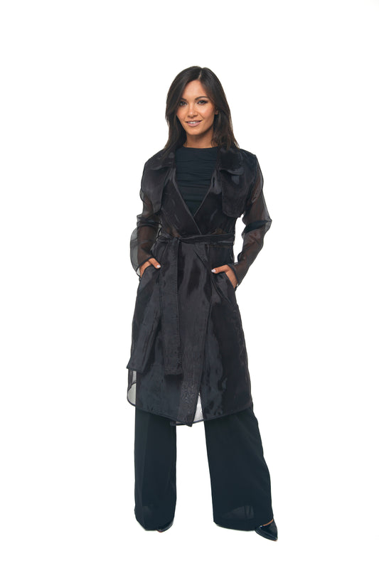 Woman wearing a black sheer coat  on a white background